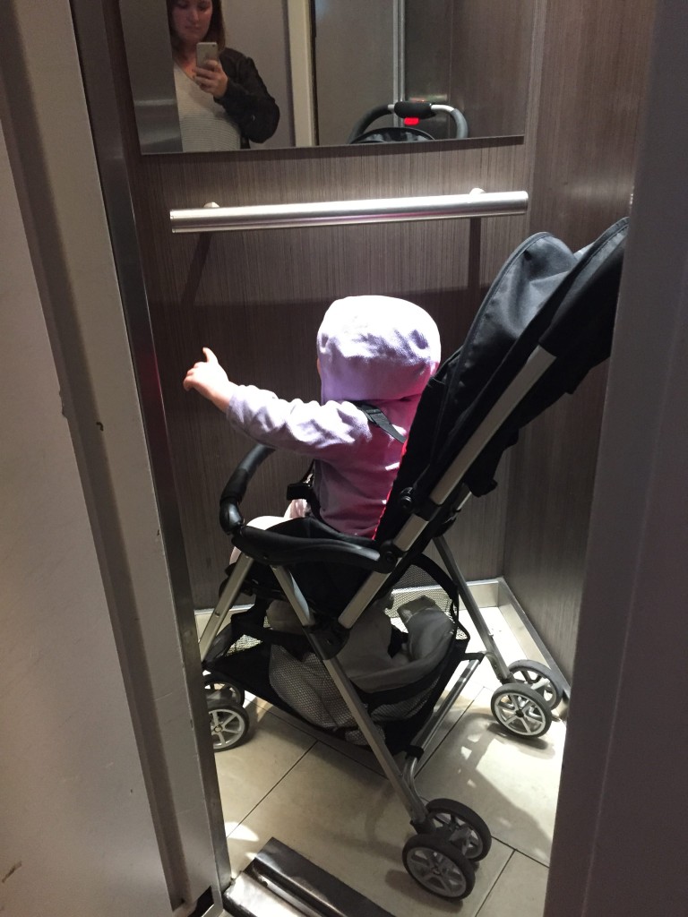 Hazel in the World's Smallest Elevator in Our Apartment in Paris. Barely enough room for a stroller!
