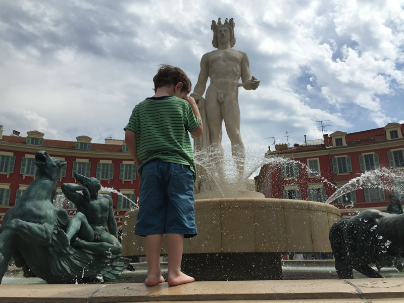 Reuben Standing On a Fountain in Nice, France